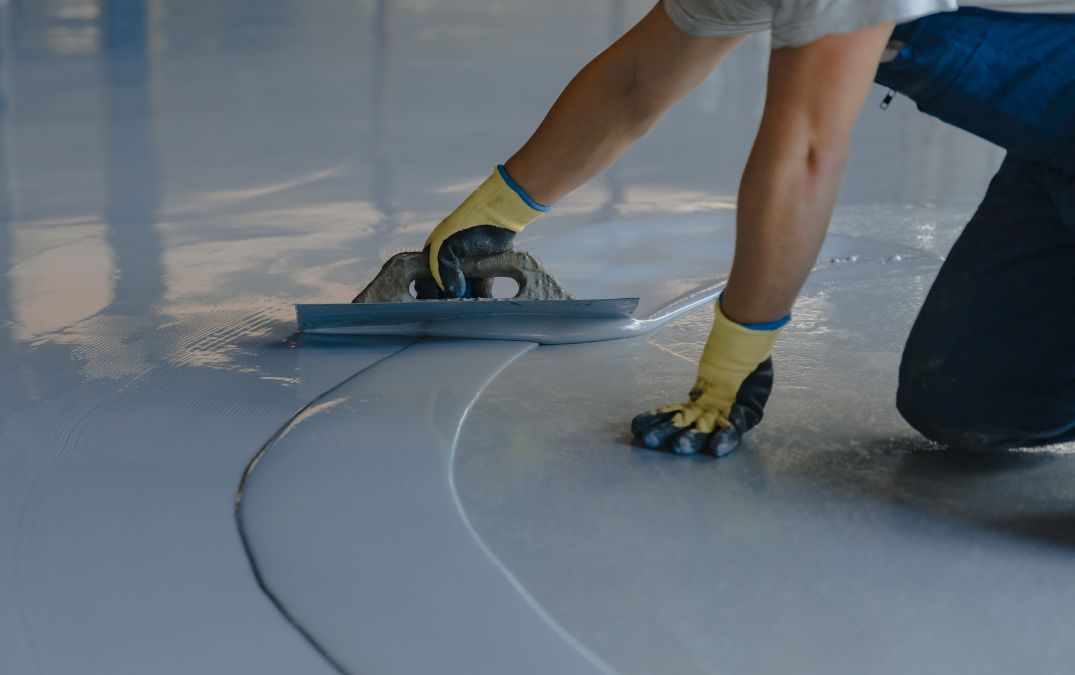 Epoxy coating being installed on a concrete floor.
